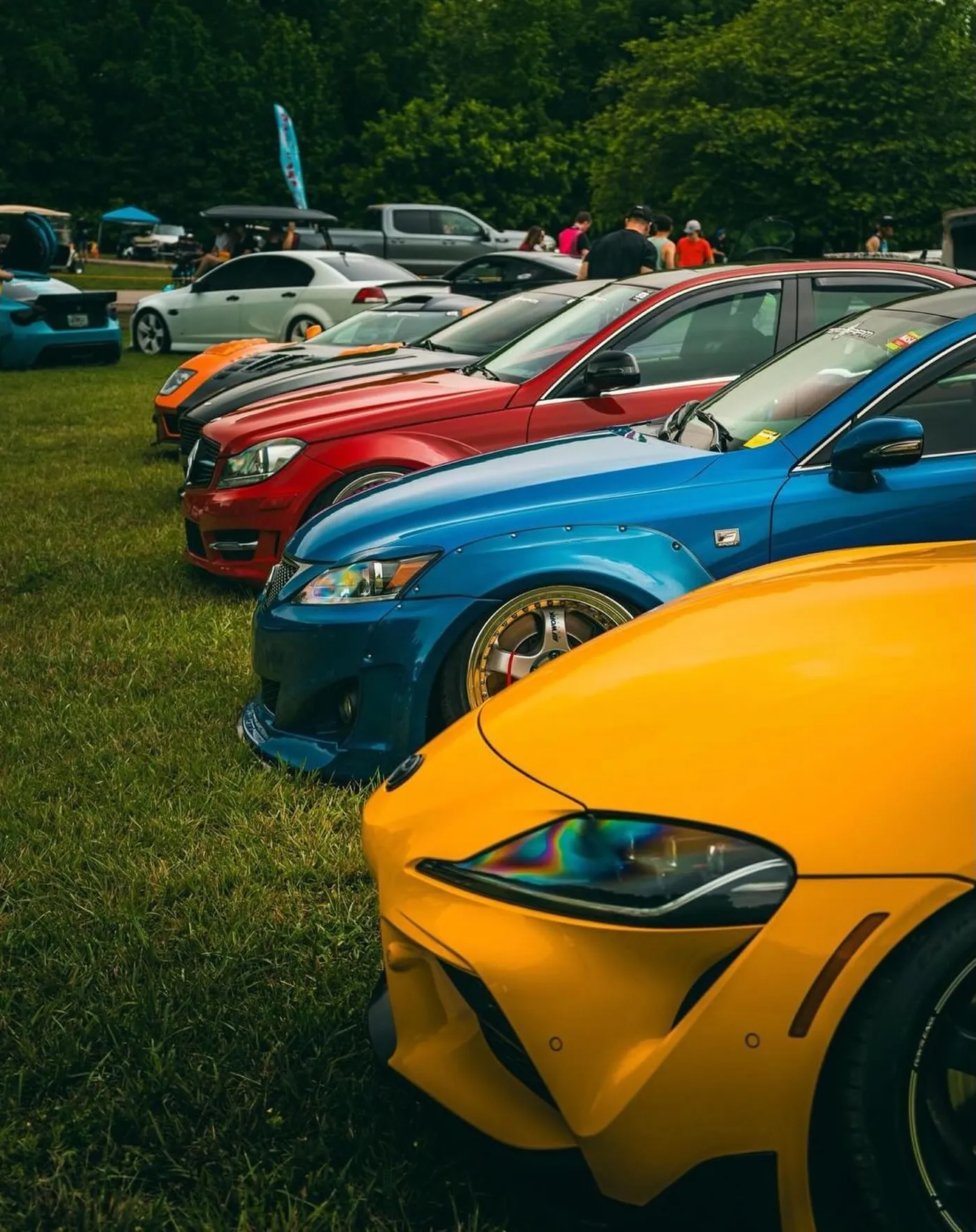 Colorful row of member cars on grass at HyperFest